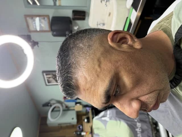 A short fade seen from above, edges cleaned up at Barber Shack.