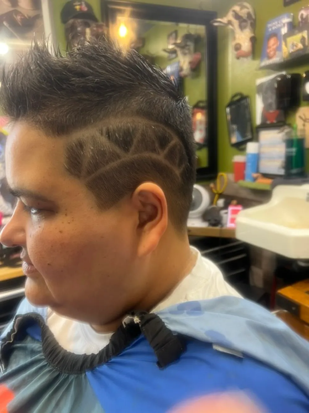 Custom hair-art design razored into a cut at Barber Shack.